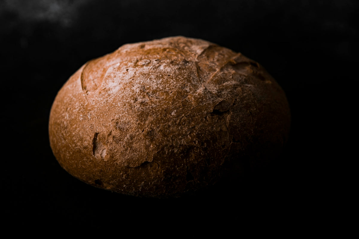 Sourdough loaf on a dark surface