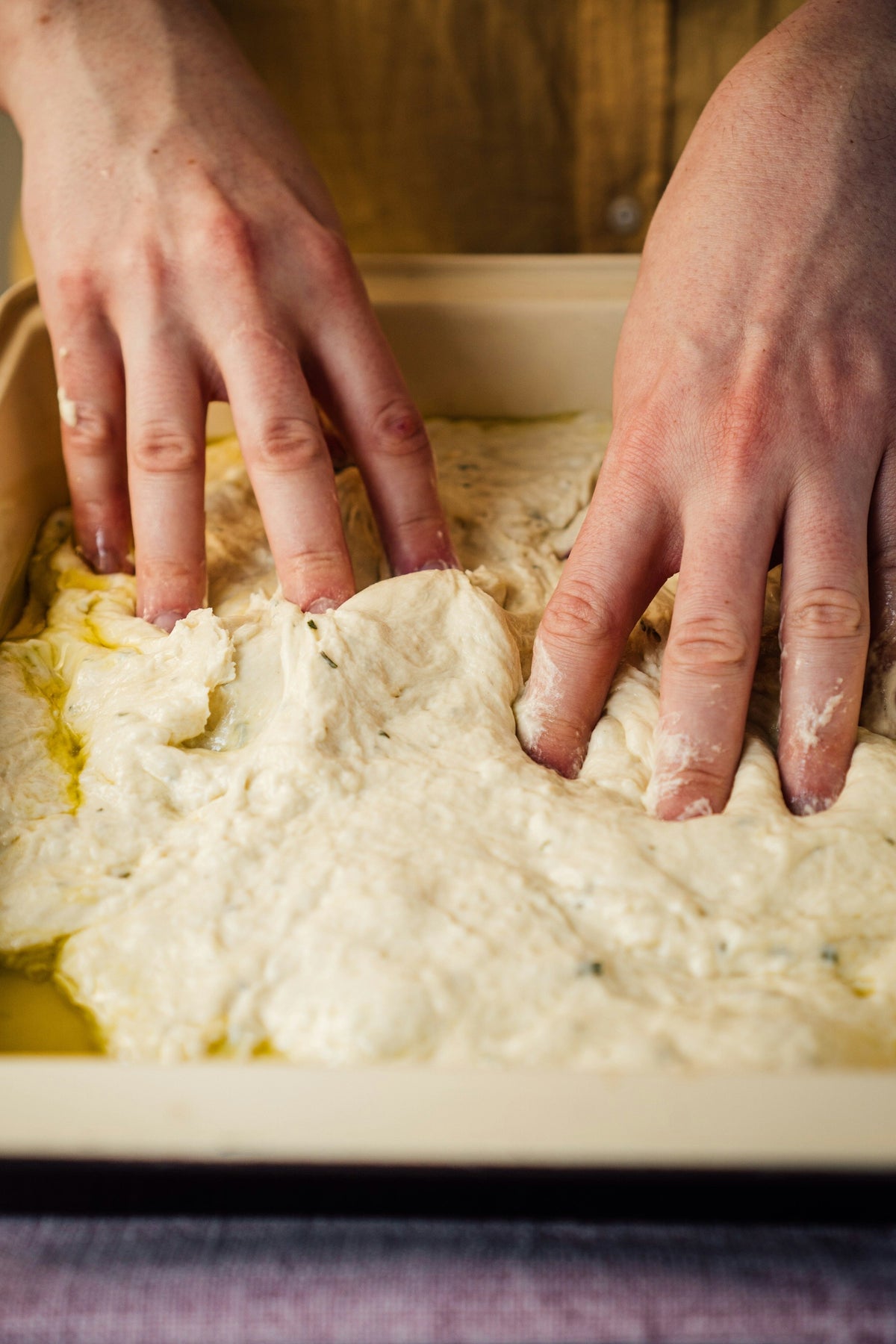 Hands shaping sourdough bread dough